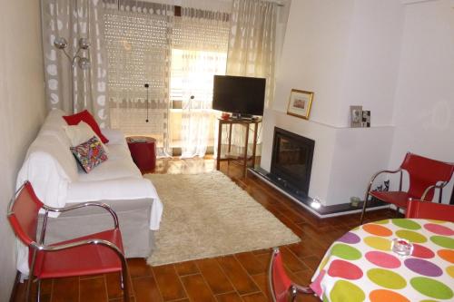 a living room with a couch and a fireplace at Porto's City Park & Surf Beach Rooms in Matosinhos
