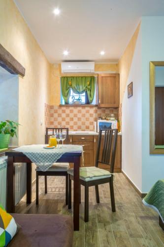 a kitchen with a table and chairs in a room at Guesthouse Villa Marija in Motovun