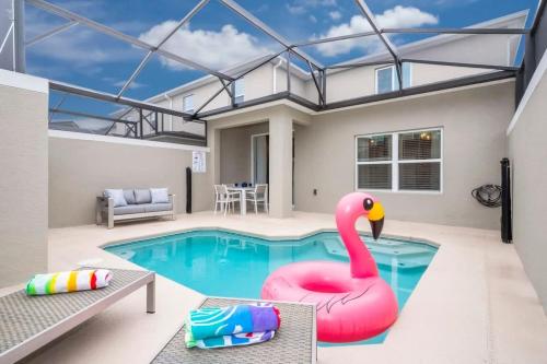 a swimming pool with a pink flamingo in a house at Stunning 5 Bd w Pool at Storey Lake Resort 2400 in Kissimmee