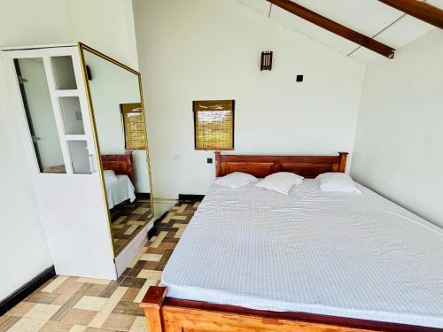 a bedroom with a bed and a mirror at LEOPARD One Villa in Gotamegama