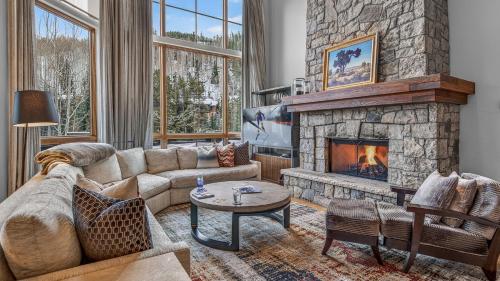 a living room with a couch and a fireplace at Bergrose Lodge in Vail