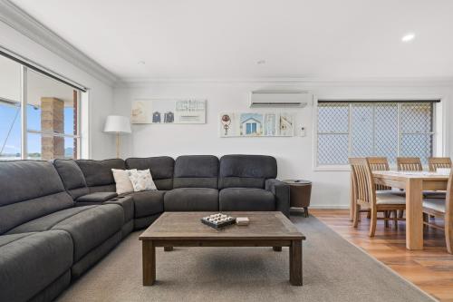 a living room with a couch and a table at The Nelson Bay Getaway in Nelson Bay