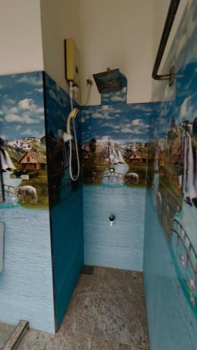 a bathroom with blue walls with a shower in it at LEOPARD One Villa in Gotamegama
