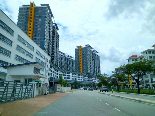 a city street with tall buildings on a cloudy day at Shah Suites Vista Alam in Shah Alam