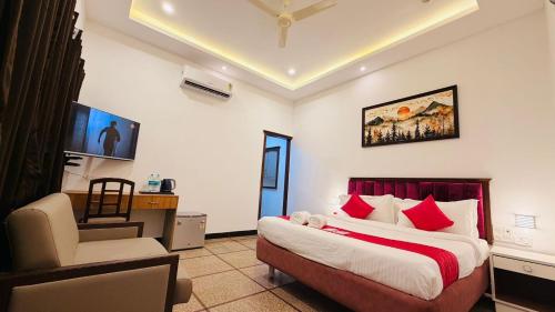 a bedroom with a bed and a desk and a chair at Sun Stayz Inn T - Nagar Chennai in Chennai