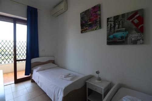 a small bedroom with a bed and a window at Casa Federica Otranto Near Beach & Center AC, WiFi & 6 Sleeps in Otranto