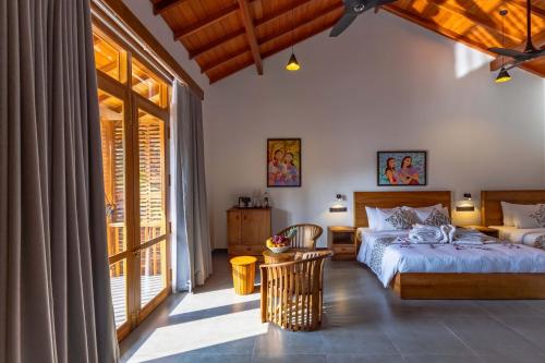 a bedroom with a bed and a large window at Villa Bentota B24 in Bentota