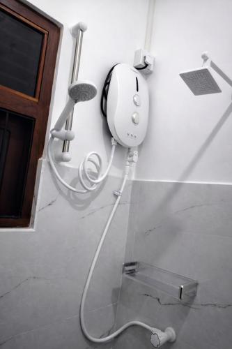 a room with a hair dryer on the floor at Wilpattu Gagana guest in Nochchiyagama