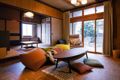 a living room with a couch and a table at Roopt仙台薬師堂 in Sendai