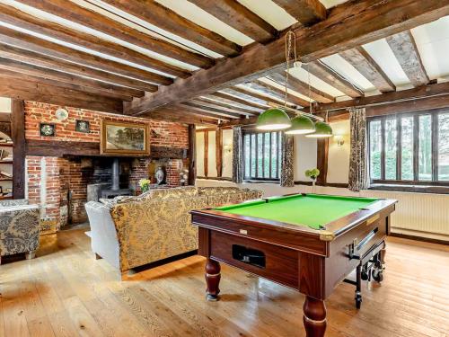 a living room with a pool table at The Farmhouse - Uk48228 in Tibenham