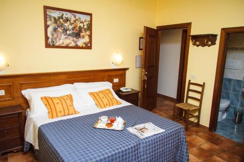 a bedroom with a bed with a blue and white checkered blanket at Hotel Nizza in Florence