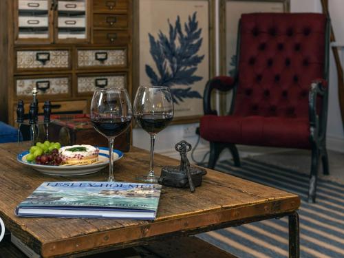 a table with two glasses of wine and a plate of food at The Salt Loft in Fowey