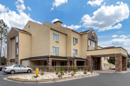 a building with a car parked in a parking lot at Comfort Inn & Suites Montgomery East Carmichael Rd in Montgomery