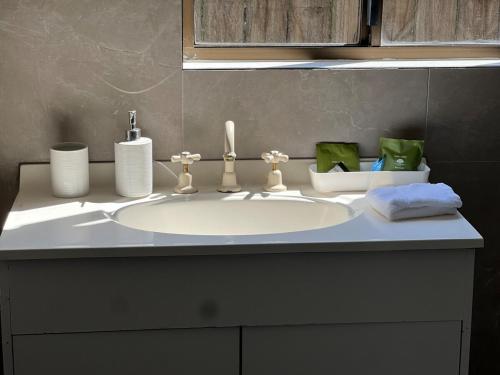 a bathroom counter with a white sink and towels at Holiday Home in Warrnambool in Warrnambool
