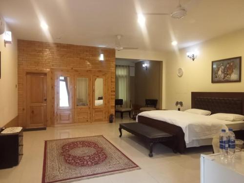 a bedroom with a bed and a room with a table at Gahirat Castle Chitral in Chitral