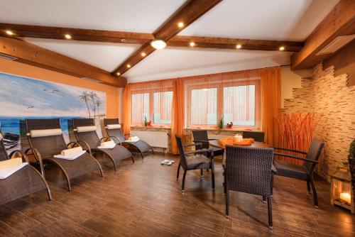 a dining room with chairs and a table and a painting at Hotel Lohninger-Schober 3 Stern Superior in Sankt Georgen im Attergau