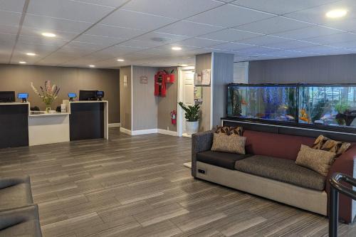 an office lobby with a large aquarium in the wall at Quality Inn & Suites Northampton - Amherst in Northampton