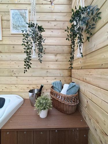 a bathroom with a sink and baskets on a wall at Location Maison Larmor plage in Larmor-Plage