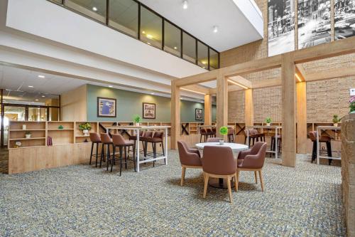 a restaurant with tables and chairs in a lobby at Radisson Hotel Philadelphia Northeast in Trevose