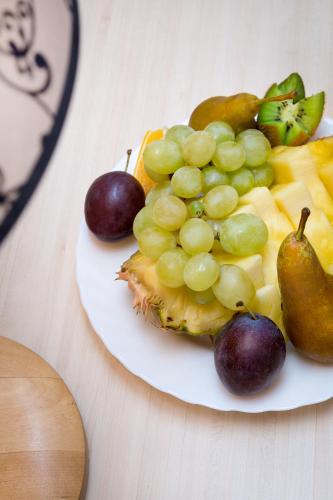 a plate of fruit on top of a table at Ivolita Vilnius in Vilnius