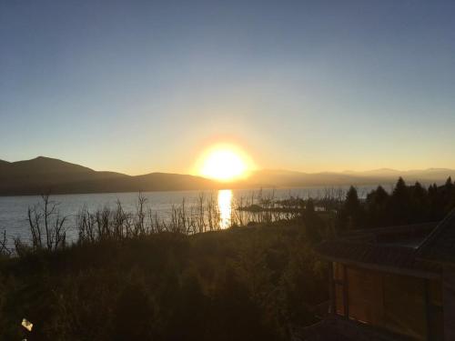 a sunset over a body of water with the sun setting at Erhaike Seaview Inn in Dali