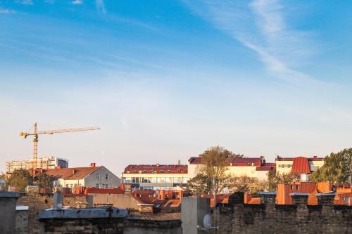 a view of a city with a crane and buildings at Ivolita Vilnius in Vilnius
