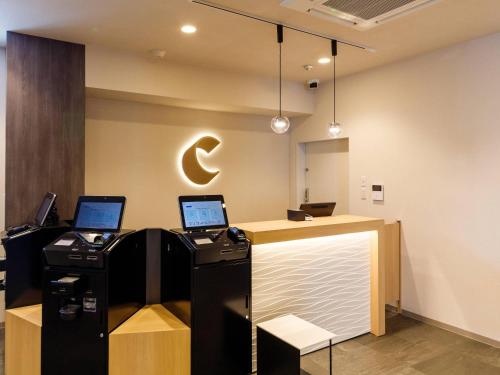 a lobby with two laptop computers on a counter at Comfort Hotel Kii Tanabe in Tanabe