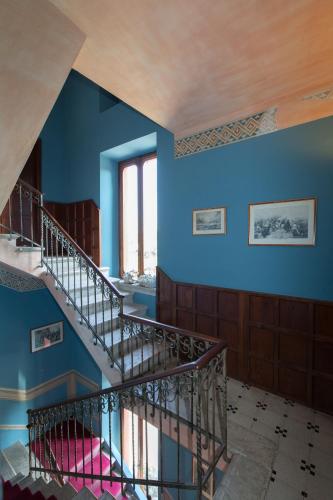 a staircase in a building with blue walls at Villa Pioppi Hotel in Sirmione
