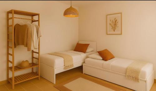 a small room with two beds and a shelf at Villa Fabi in Brindisi
