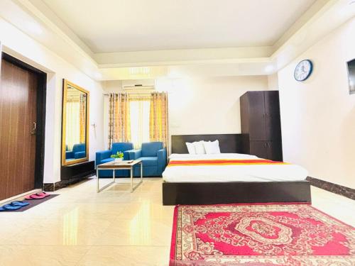 a hotel room with a bed and a rug at Hotel Progati Inn Ltd. in Dhaka