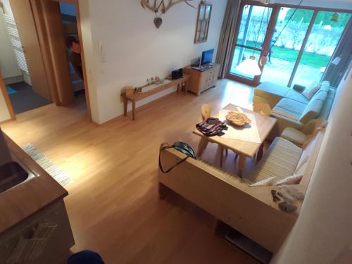 an overhead view of a living room with a couch and a table at Haus Jelini in Schnepfau