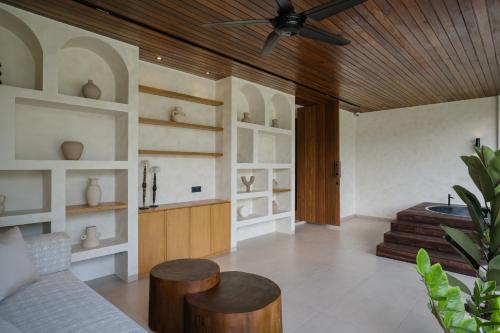 a living room with a couch and a ceiling fan at Kono Villas & Resort in Ungasan