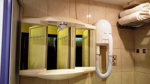 a bathroom with a sink and a mirror at TAFERNINE STUDIO in the heart of Mosta in Mosta