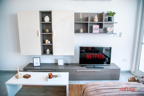 a living room with a tv and a coffee table at Pretty Beachfront Penthouse in Mellieha in Mellieħa