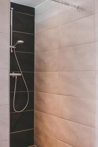 a bathroom with a shower with a glass door at Boerderij Zonneveld in Rossum