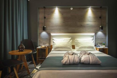 a bedroom with a large bed with two pillows at Hotel Cura in Canakkale