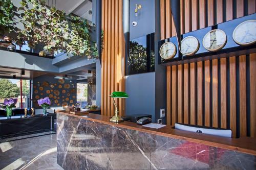 a lobby with clocks hanging on the wall at Hotel Cura in Canakkale