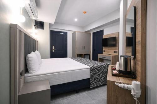 a hotel room with a bed and a kitchen at Nas Corner Hotel in Antalya