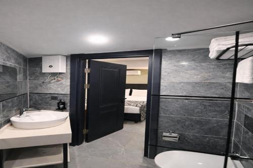 a bathroom with a sink and a toilet and a shower at Nas Corner Hotel in Antalya
