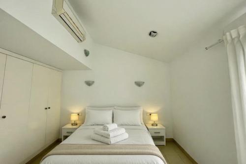 a bedroom with a bed with towels on it at Villa Son Blanc 5 in Sa Caleta