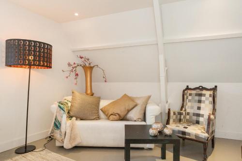 a living room with a couch and a chair at Apartment Naarden-Vesting in Naarden