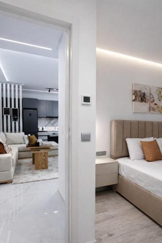 a white room with a bed and a living room at Sirena Apartment Tangier in Tangier