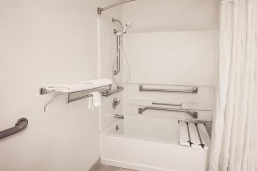 a bathroom with a shower with a shower curtain at Super 8 by Wyndham Grove City in Grove City