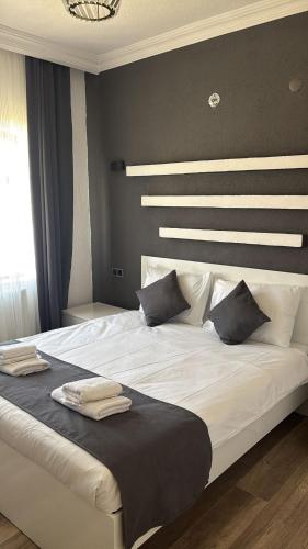 a bedroom with a large white bed with pillows at loopy lodge hotel in Ürgüp