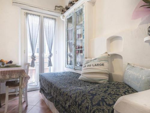 a bedroom with a bed and a table and a window at B&B Antiche Porte in Rimini