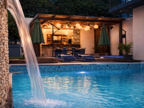 a pool with a water fountain in a backyard at 13 on Tenth in Walmer