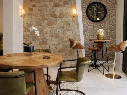 a room with a table and chairs and a clock at 13 on Tenth in Walmer