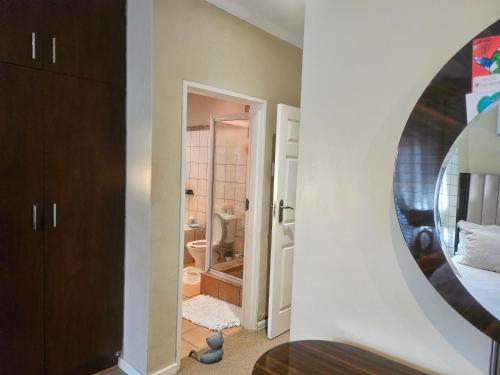 a room with a mirror and a bathroom at 20 in Crescent in Gqeberha