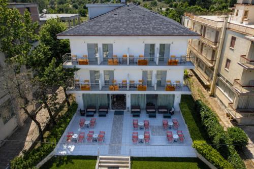 an aerial view of a white house with chairs and tables at Hotel Ena - Elegant Mountain View Stay with Pool in Loutra Ipatis