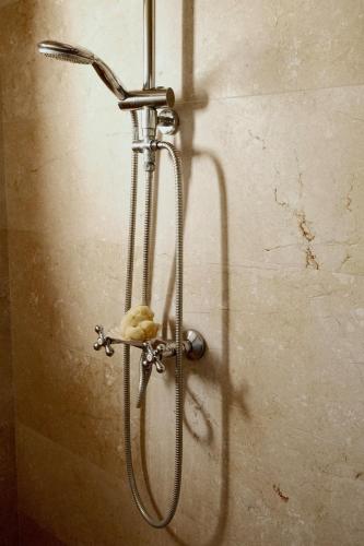 a shower with a shower head on a wall at La Molina Mallorca in Felanitx